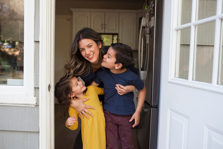 Mother with two children in a doorway
