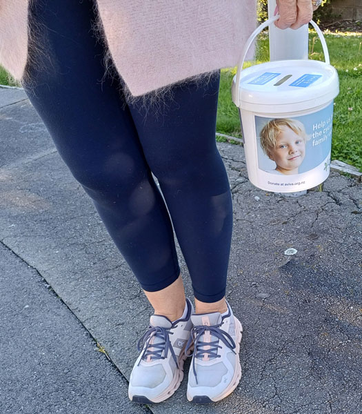 An Aviva donation bucket with the words, "Everyone deserves to feel safe in their own home"