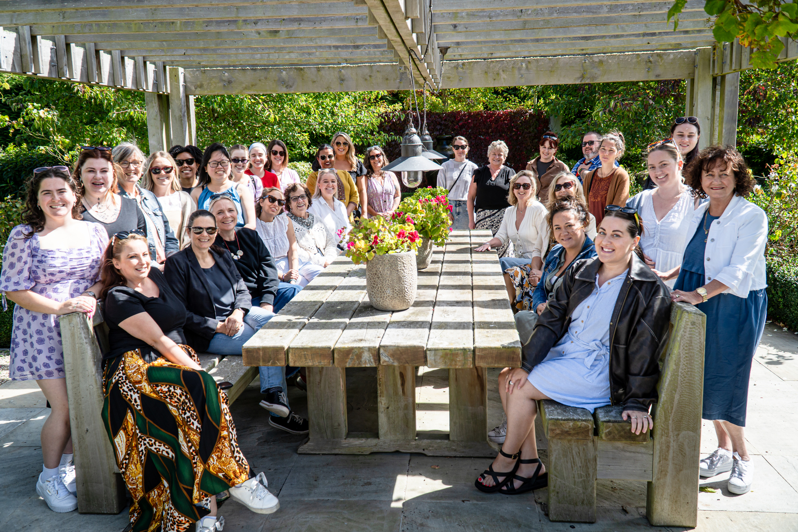 Aviva staff sit in the sun at a large picnic table
